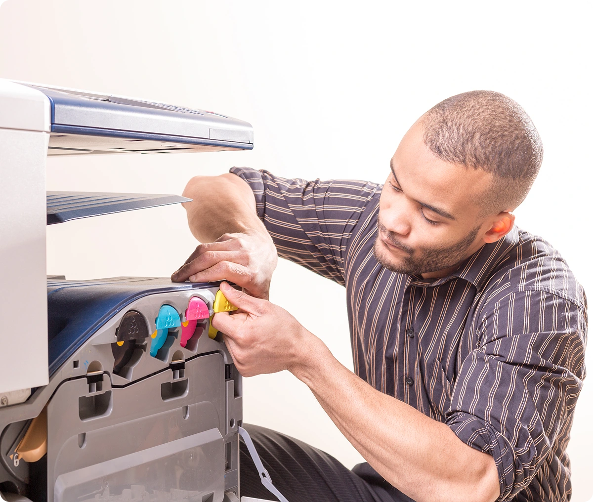 Man replacing printer ink cartridges.