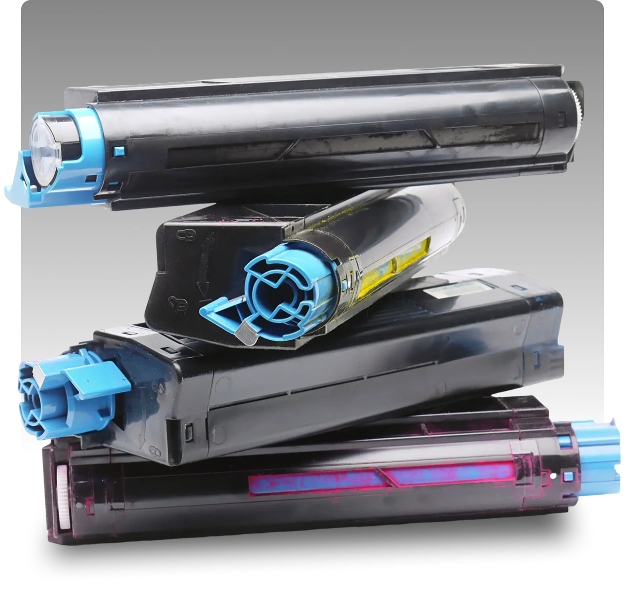 Stacked printer toner cartridges on gray background.